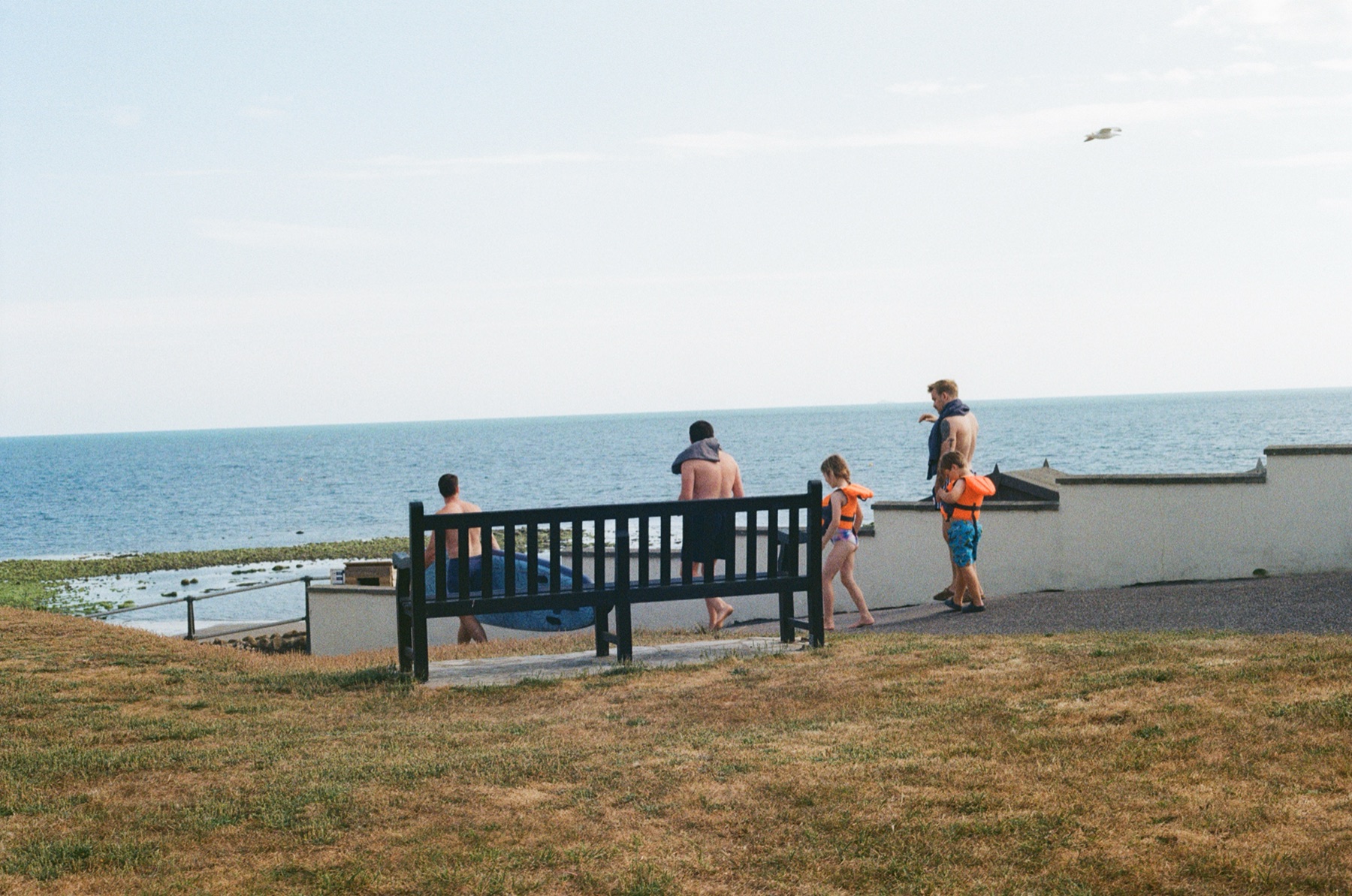 Walking to the beach with the required parafernalia for a good time. I like the vantage point of this shot. Before the fun begins.
